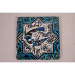 An Islamic pottery tile decorated with Middle Eastern birds and a turquoise blue glazed edge, 8" x