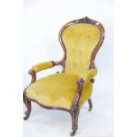 A Victorian walnut spoon back armchair with carved show wood decoration, cabriole legs and fibre