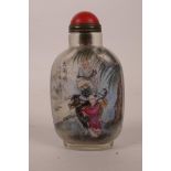 A Chinese reverse painted glass snuff bottle decorated with figures riding a buffalo and a river