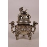 A Chinese white metal censer on tripod supports with two handles in the form of dragons and a fo dog