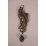 A Chinese white metal rattle in the form of a robed figure, 3½" long