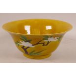 A Chinese Sancai porcelain bowl painted with flowering branches, seal mark to base, A/F, 8" diameter