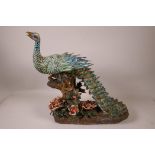 A Chinese polychrome porcelain peacock, 14½" long, 14½" high, A/F, impressed marks verso