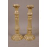 A pair of sectional turned bone candlesticks with carved decoration, 7½" high