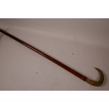 A C19th Malacca walking cane with carved horn handle and 18ct gold ferrule, 33" long