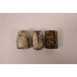 Three Chinese marbled jade beads with character inscriptions and carved archaic decoration, 1"