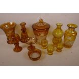 A quantity of etched and cut amber glassware including biscuit barrel, perfume decanter, glasses etc