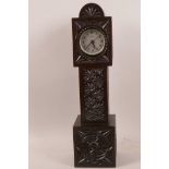 An elaborately carved mahogany miniature long case clock, 13½" high
