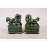 A pair of Chinese green glazed porcelain seals with two fo dog knops, 4" high