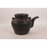 A Chinese black ground Yixing teapot with two handles, impressed marks to base and lid, 6" high