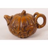 A Chinese carved boxwood ornament in the form of a pumpkin teapot, 3" long