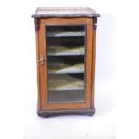 A Victorian inlaid rosewood music cabinet, with pierced brass gallery top, and single glazed door,