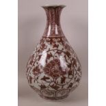 A Chinese pear shaped porcelain vase decorated in red/brown with stylised flowers, 12½" high