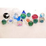 A collection of glass paperweights, including Caithness