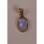 A yellow metal pendant set with a moonstone