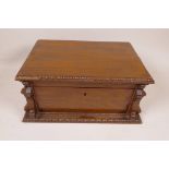 A mahogany jewellery box of architectural form with beaded decoration, 10" x 7" x 5", containing a