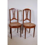 A pair of French mahogany side chairs, with brass mounts and banded inlaid decoration, pierced splat