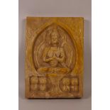 An Oriental ochre glazed pottery tile with raised decoration of Buddha, 7" x 10"