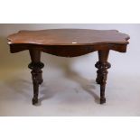 A C19th rosewood centre table, with shaped top and single frieze drawer, raised on carved and
