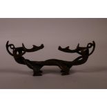 A Chinese bronze brush rest in the form of entwined dragons, 6½" long