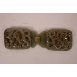 A Chinese celadon jade belt buckle with carved and pierced dragon decoration, 5½" x 2"