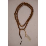 A string of Islamic palm fruit kuka prayer beads, 38" long