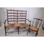 An Arts and Crafts two seat ladderback settee with seagrass seats, 45" wide, and a stick back