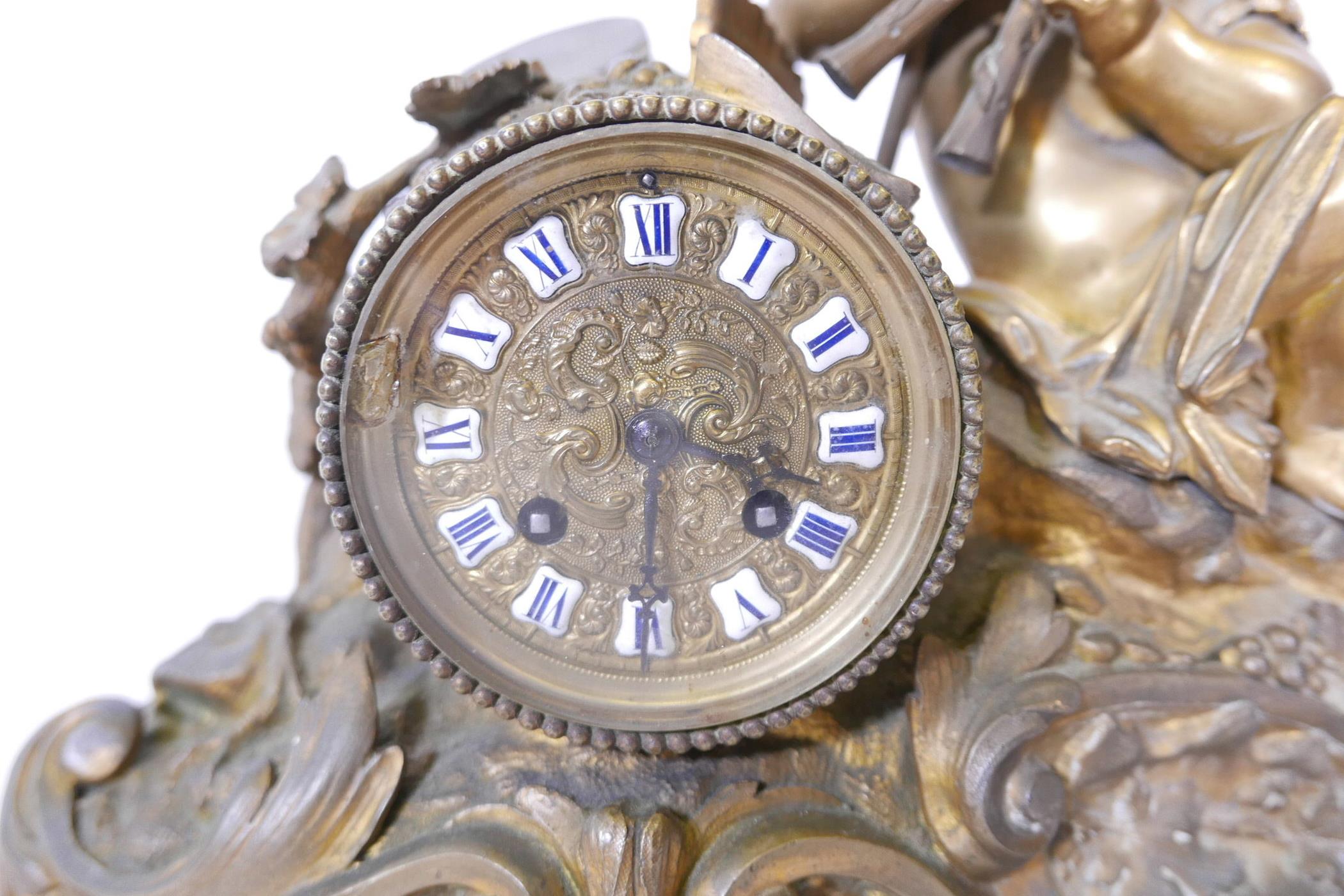 A French brass Rococo style mantel clock surmounted by a putti playing an aulos, with a brass dial - Image 2 of 4