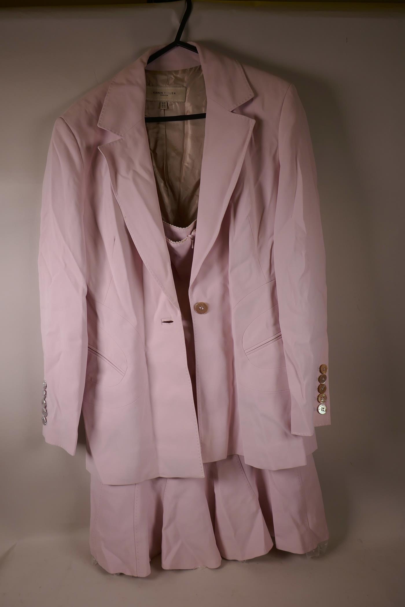 A Karen Millen pink acetate two piece suite of skirt and jacket, size 14