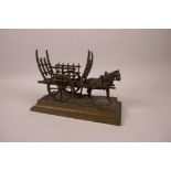 A bronze of a horse pulling a Continental hay cart, 7" long