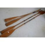 A pair of vintage wooden oars, 78" long, and a pair of vintage wooden two blade paddles, 96" long