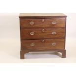 A Georgian mahogany chest of three drawers with moulded fronts and brass oval plate handles,