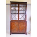 A C19th mahogany bookcase with astragal glazed top over two doors, 46" x 17" x 87", raised on