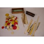 A quantity of Chinese dyed bone gaming chips together with a box of bone and wood gaming sticks, a