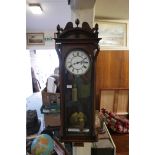 A C19th Vienna wall clock with a brass and enamel dial and Roman numerals, the movement striking