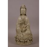 A Chinese blanc de chine figure of Quan Yin seated on a lotus flower, impressed marks verso, 10"