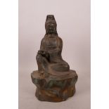 A Chinese bronze of Quan Yin with gilt and verdigris patina, 4 character mark verso, 8½" high