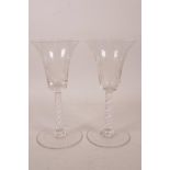 A pair of Georgian wine glasses with air twist stems and etched vine and bird decoration, 6½" high