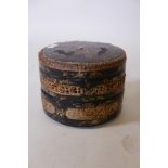 A Chinese three section lacquered food container with raised gilt decoration, A/F, 10" diameter,