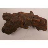 A carved rootwood temple figure with man's face, mythical beast and temple steps, 7" long