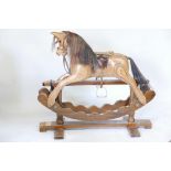 A carved plywood rocking horse, bears label Ian Armstrong, rocking horse maker, Durham, 38" high