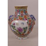 A small Chinese porcelain vase of bulbous form decorated with many flowers in bright polychrome