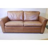 A two seater leather upholstered sofa, 78" x 37" x 26"