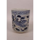 A Chinese blue and white pottery brush pot decorated with a phoenix and flowers, 4½" high x 4"
