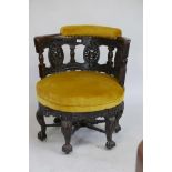 A Colonial carved show wood tub chair raised on five carved cabriole legs with petal feet and ball