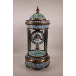 A brass and cloisonné cased cylinder mantel clock with an open movement striking on a gong and a