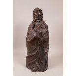 A Chinese carved hardwood figure of a bearded sage, 14½" high