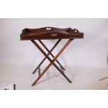 A C19th mahogany butler's tray with folding stand, 18" x 30"