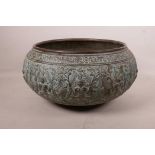 An Indian bronze bowl with repoussé figural decoration and verdigris patina, 13" diameter