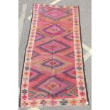 An antique Afghan Kilim rug with geometric medallion decoration, 102" x 49"